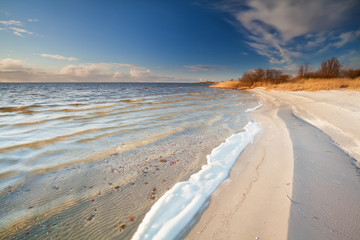 sunny evening on Ijsselmeer lake coast