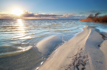 sunshine over big Ijsselmeer lake coast