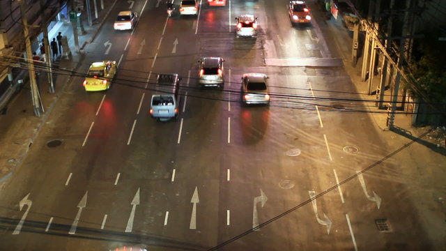 BANGKOK, THAILAND - Aerial view on road. Road traffic in night from high above. Cars and colorful taxi.