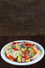 Salad with ham, paprika, corn,cheese and red onion