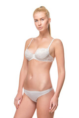 Obraz premium Young blonde woman in white underwear, studio