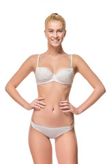 Fototapeta premium Young blonde woman in white underwear, studio