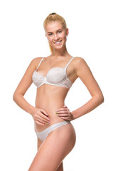 Fototapeta premium Young blonde woman in white underwear, studio