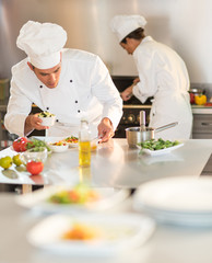 Obraz na płótnie Canvas Two chefs are working in a starred restaurant kitchen.
