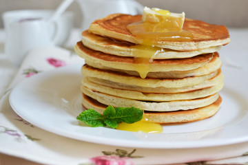 Fototapeta na wymiar Pancakes for breakfast with butter and honey