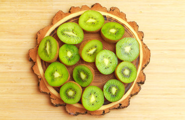Kiwi fruit on the tree timber cut board.