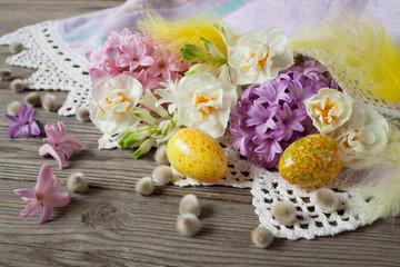 Easter wooden background with flowers hyacinths, daffodils and eggs