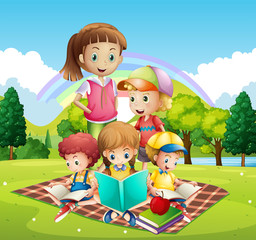 Obraz na płótnie Canvas Children reading books in the park