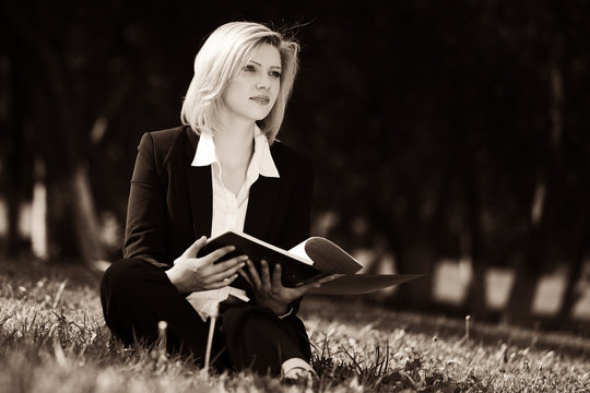 Young Business Woman With A Folder On Nature