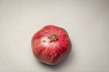 Whole Pomegranate on a blue grey background