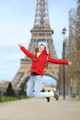Young woman near the Eiffel tower, in Paris, France