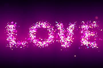 “love” formed by sparkling heart-shaped glitter in shades of pink and turquois in front of a purple background