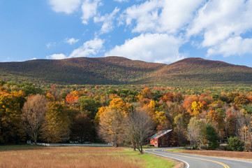 Fall foliage in upstate New York, Hudson Valley. Winding country road through the Catskill mountains.
