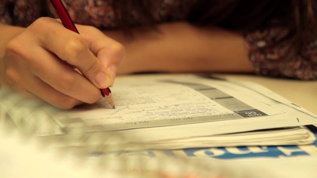 Woman studies and she thinks about answers of test