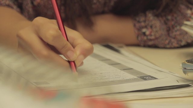 Woman studies and she thinks about answers of test