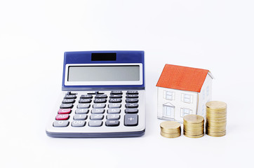 Calculator with paper house and coins stack on white backgrounds