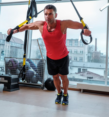 A man training with gymnastic rings.