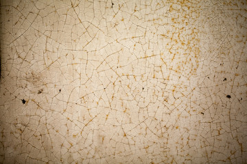 Close-up of cracked paint texture, light brown