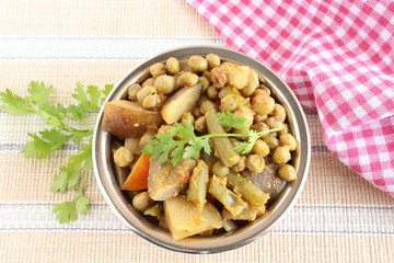 Indian food home-made vegetarian curry, prepared from vegetables like eggplant, peas, tomato and onion, is used as a side dish for items like chapati.
