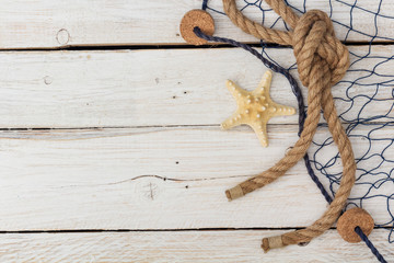 starfish, marine network and rope on the old board