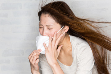 花粉症　くしゃみをする若い女性