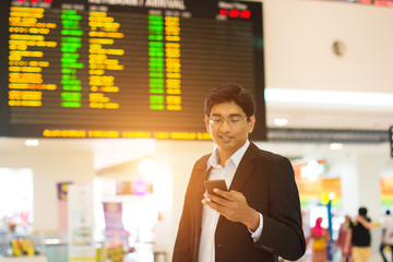 indian male at airport terminal in the early morning