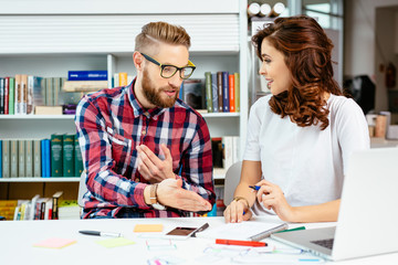 Fototapeta premium Coworkers sharing their knowledge at modern office during busine
