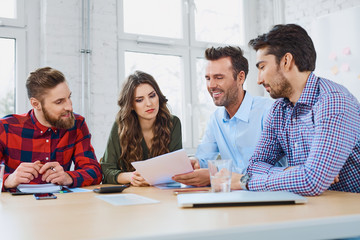 Happy teacher explaining test result to students
