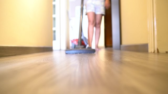Cleaning the floor with vacuum cleaner