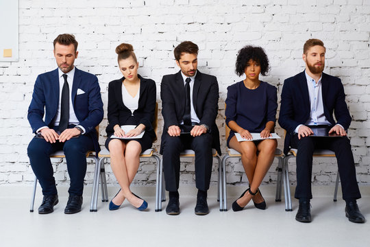 Stressful young business people waiting for job interview