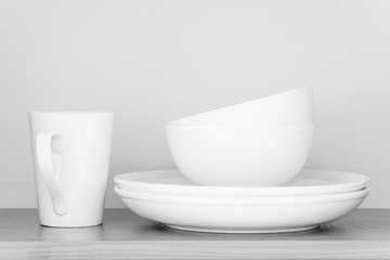 White coffee cup and white bowl in kitchen cabinet