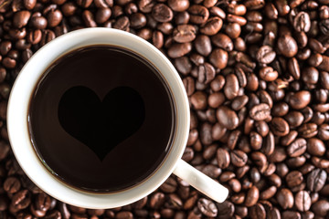 Coffee cup over coffee beans