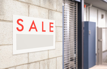 Sale Real Estate Sign in Front of house