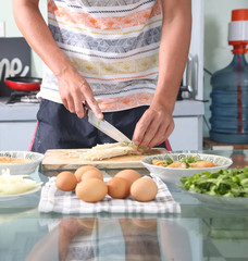 Man preparing enoki mushrooms in the kitchen