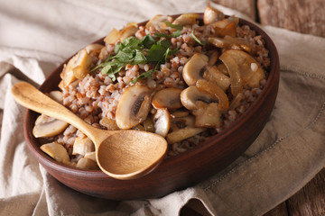 Russian cuisine: buckwheat porridge with mushrooms close-up. horizontal
