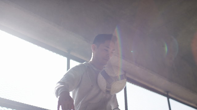 Handheld shot of soccer freestyle player doing tricks with the football