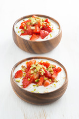 dessert of yogurt with fresh strawberries and pistachios 