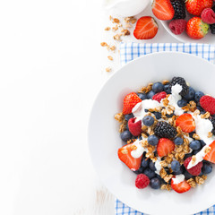 fresh berries, yogurt and granola for breakfast 