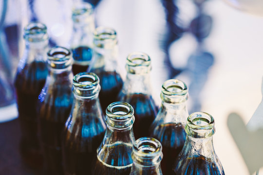 Refreshing Brown Soda in bottles in Candy Bar On Table