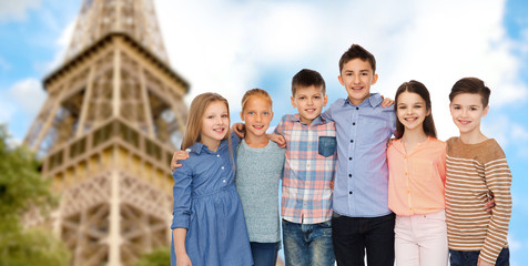 happy smiling children hugging over eiffel tower