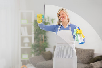 Woman cleans window in house