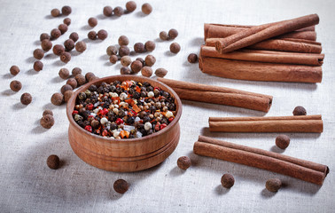 Spices in a wooden bowl, ceramic spoon, pepper, thyme, cinnamon,