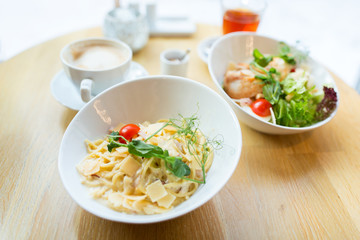 close up of pasta in bowl on table at restaurant