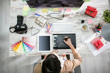 woman designer working on the pen table. - Powered by Adobe