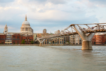 Fototapeta na wymiar Millennium bridge and St Paul cathedral in the afternoon, warm light