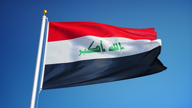Iraq flag waving in slow motion against clean blue sky, seamlessly looped, close up, isolated on alpha channel with black and white luminance matte, perfect for film, news, digital composition