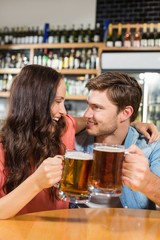 Couple toasting with beers