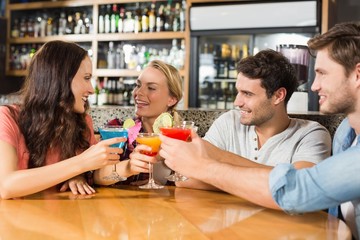 Friends toasting with cocktails