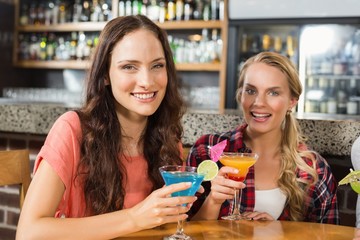 Women holding glasses of cocktail