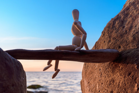 Wooden figurine at the coast